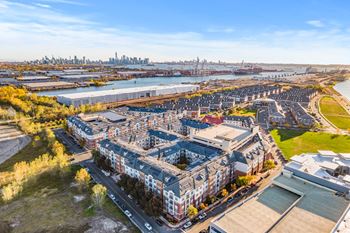 an aerial view of an apartment complex with a city in the background at Harbor Pointe, New Jersey, 07002